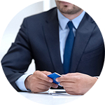 A man in a suit holds a credit card, symbolizing financial support for asylum